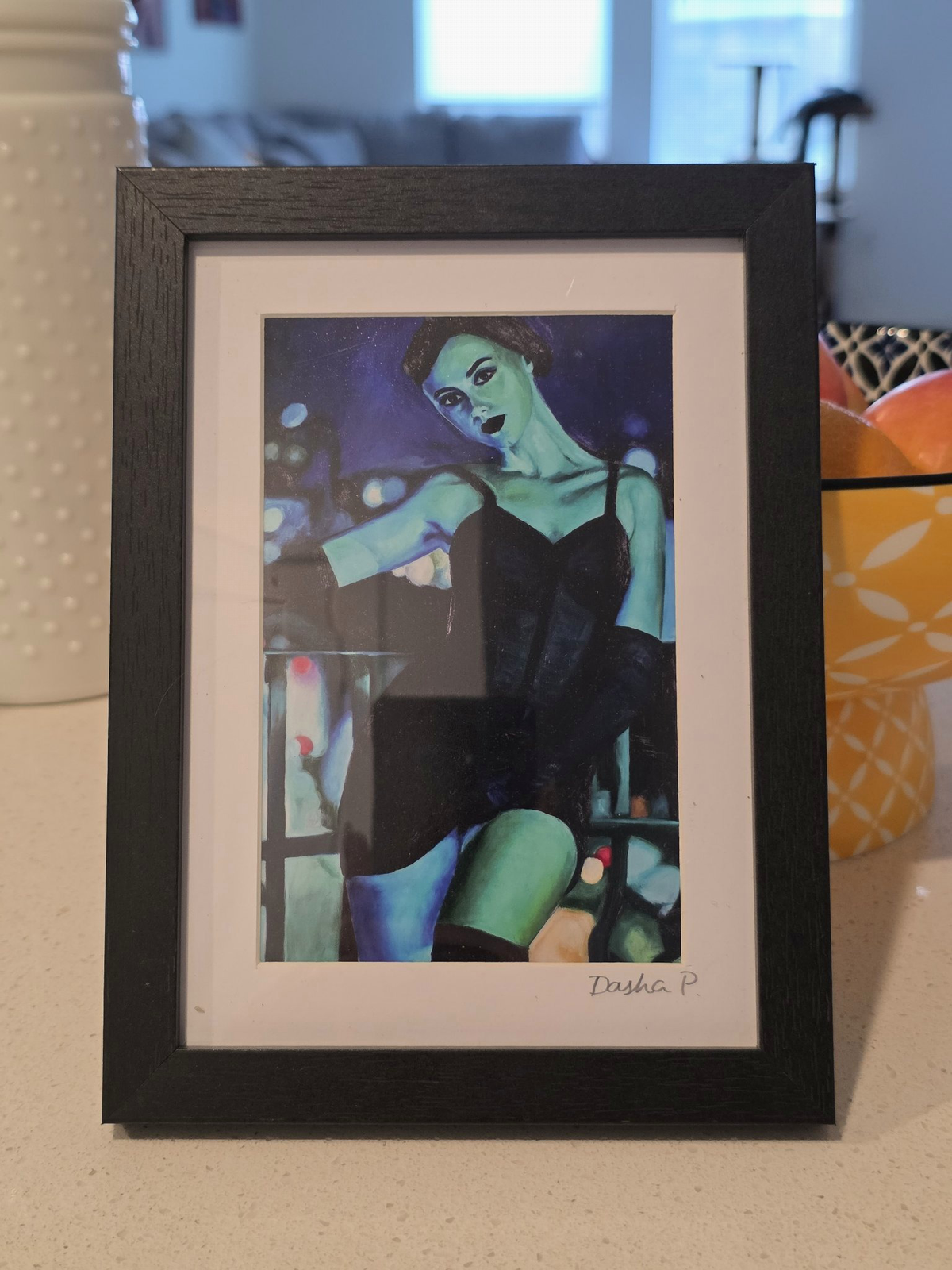 Just a Hit signed matted framed art print by Dasha Prudnikova, showing a green-lit woman in a black dress in a black frame with white mat.
