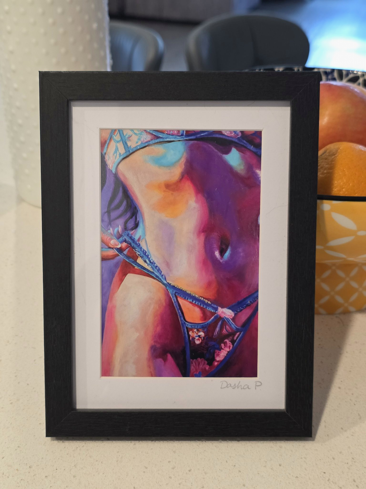 Tease signed matted framed art print by Dasha Prudnikova, a colorful close-up figure painting in a black frame with white mat.