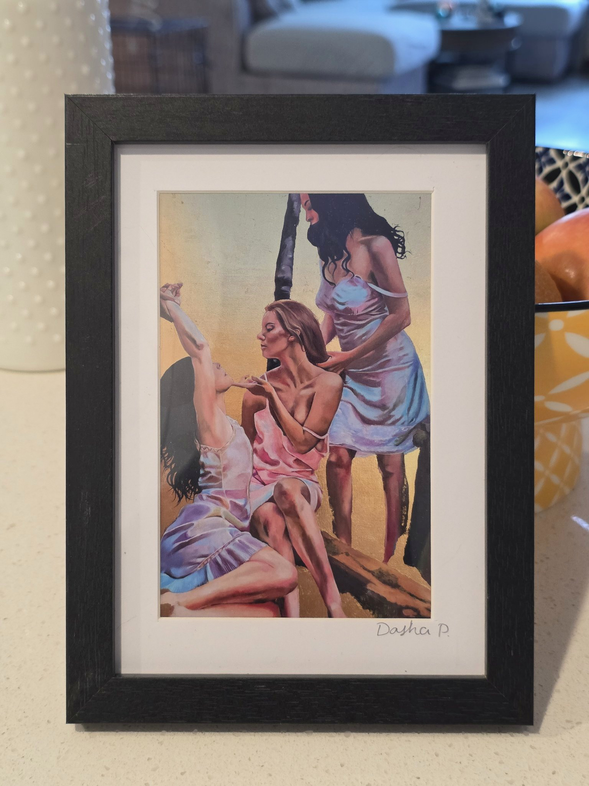 Three Graces signed matted framed art print by Dasha Prudnikova, showing three women in pastel dresses in a black frame with white mat.